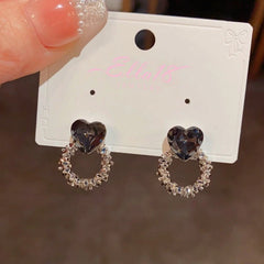 Angled view of the 14K Gold-Plated Black Diamond Heart Hoop Earrings