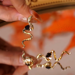 Angled view of the 14K Gold-Plated Black Diamond Snake Earrings