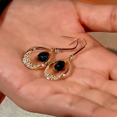 Angled view of the 14K Gold-Plated Blue Crystal Water Drop Ear Hook Earrings