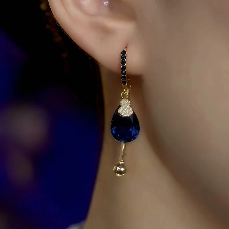 Model showcasing the dangle and style of the 14K Gold-Plated Blue Diamond Water Drop Earrings
