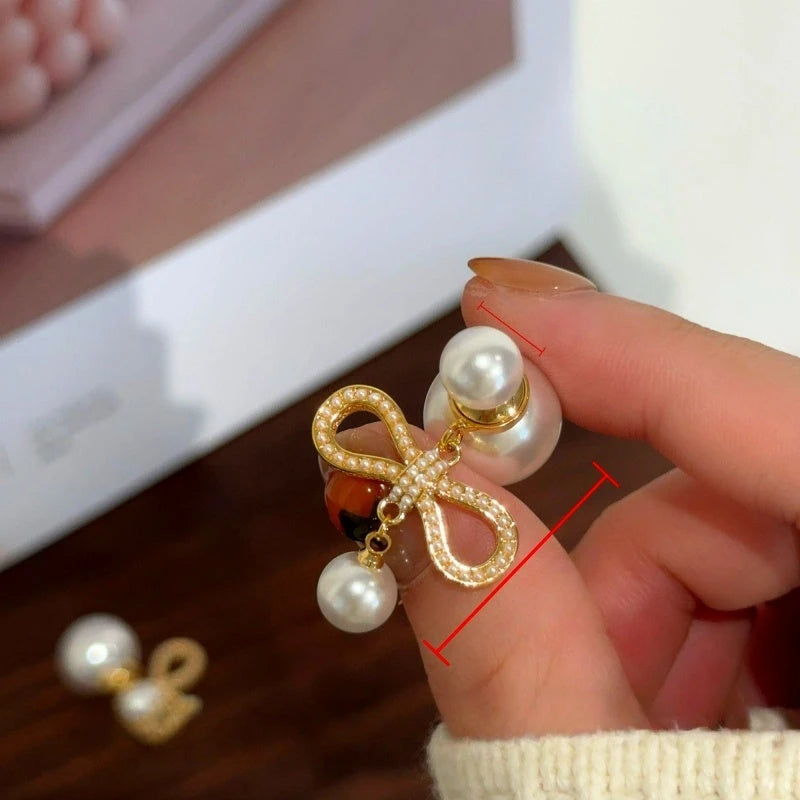 Close-up detail of the sparkling zircons and plating on the Bow Pearl Earrings