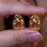 Pair of gold teardrop stud earrings with champagne crystal and peach opal accents