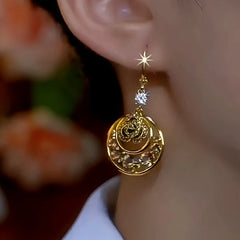 Model showcasing the dangle and style of the 14K Gold-Plated Brown Diamond Mesh Hoop Earrings