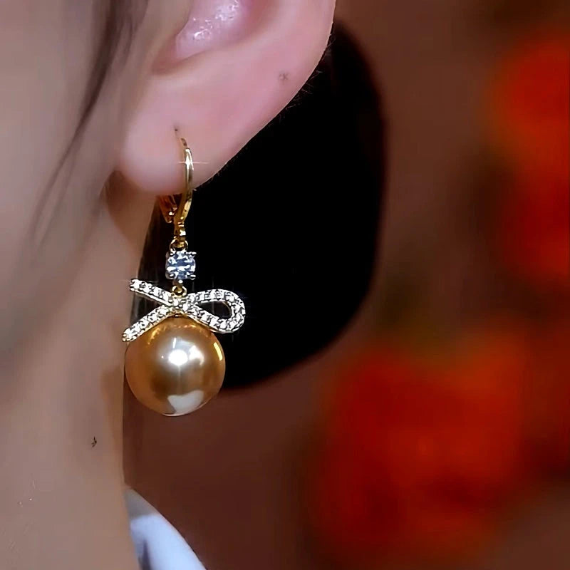 Close-up detail of the sparkling zircons and plating on the Pearl Bow Earrings