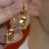 Pair of textured gold square drop earrings with champagne crystal gems