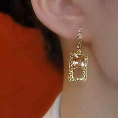 Champagne crystal gold square drop earring, worn ear side close-up