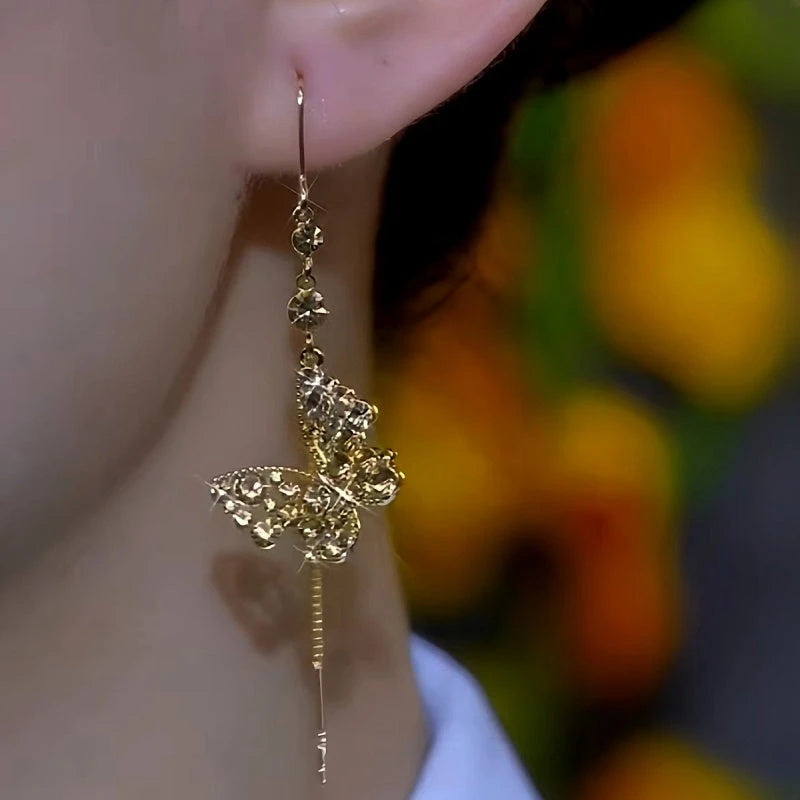 Model showcasing the dangle and style of the 14K Gold-Plated Brown Zircon Diamond Butterfly Threader Tassel Earrings