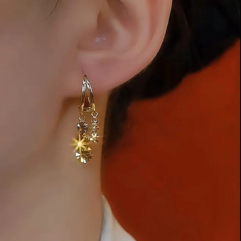 Model showcasing the dangle and style of the 14K Gold-Plated Brown Zircon Tassel Earrings