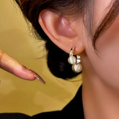 Model showcasing the dangle and style of the 14K Gold-Plated Brushed Bead Earrings