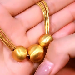 Detailed view of the 14K Gold-Plated Brushed Happy Family Three Ball Necklace chain and pendant