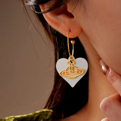 Close-up detail of the sparkling zircons and plating on the Heart Saturn Earrings