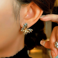 Model showcasing the dangle and style of the 14K Gold-Plated Butterfly Earrings