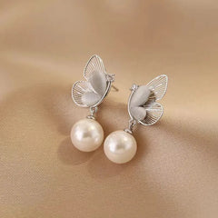 Close-up detail of the sparkling zircons and plating on the Butterfly Pearl Earrings