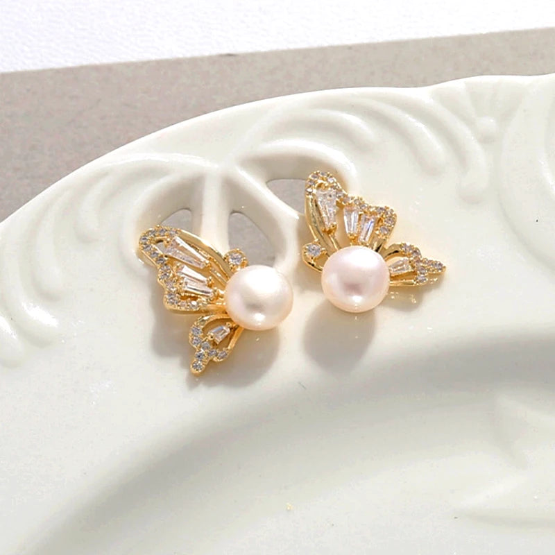 Angled view of the 14K Gold-Plated Butterfly Pearl Stud Earrings