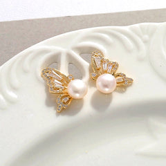 Angled view of the 14K Gold-Plated Butterfly Pearl Stud Earrings