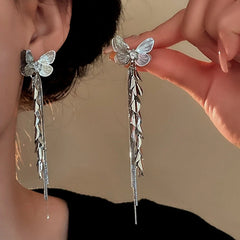 Model showcasing the dangle and style of the 14K Gold-Plated Butterfly Tassel Earrings