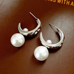 Model showcasing the dangle and style of the 14K Gold-Plated C-Shaped Bead Earrings