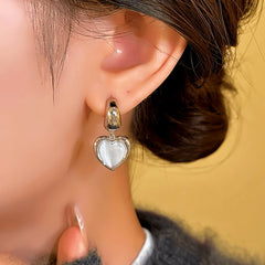 Model showcasing the dangle and style of the 14K Gold-Plated Cat Stone Heart Earrings