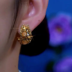 Close-up detail of the sparkling zircons and plating on the Cat's Eye Earrings