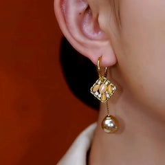 Close-up detail of the sparkling zircons and plating on the Geometric Tassel Earrings