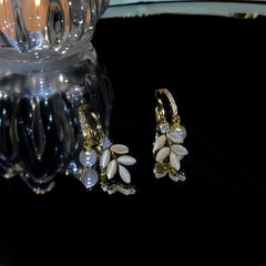 Close-up detail of the sparkling zircons and plating on the Pearl Leaf Earrings