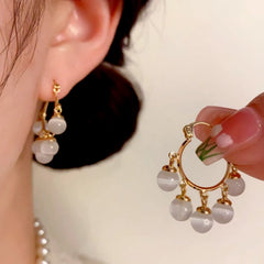 Close-up detail of the sparkling zircons and plating on the Tassel Earrings