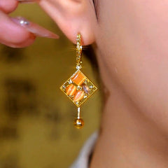 Angled view of the 14K Gold-Plated Cat's Eye Stone Diamond Water Drop Earrings
