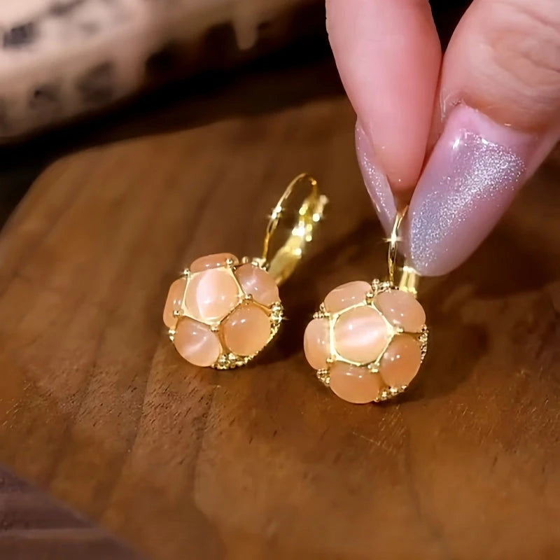 Model showcasing the dangle and style of the 14K Gold-Plated Cat's Eye Stone Earrings