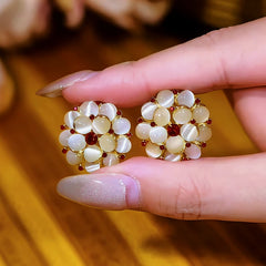 Angled view of the 14K Gold-Plated Cat's Eye Stone Flower Stud Earrings