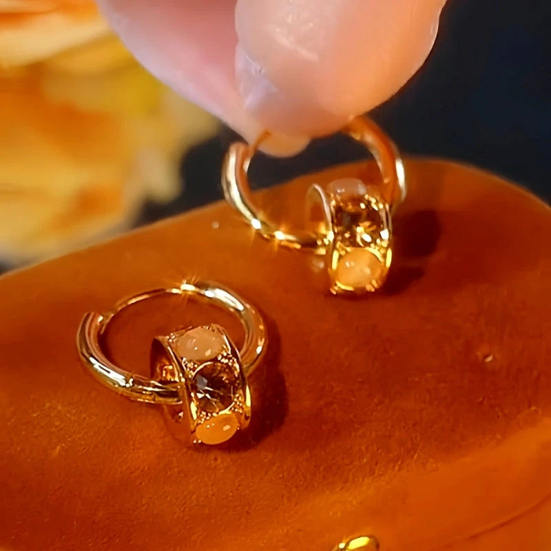 Angled view of the 14K Gold-Plated Cat's Eye Stone Hoop Earrings