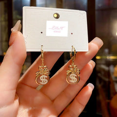 Angled view of the 14K Gold-Plated Cat's Eye Stone Lucky $ Bag Earrings