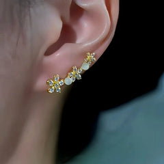 Gold flower cat's eye crystal ear climber worn on opposite ear