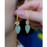 Pair of gold crystal flower long drop earrings with light green leaf pendants