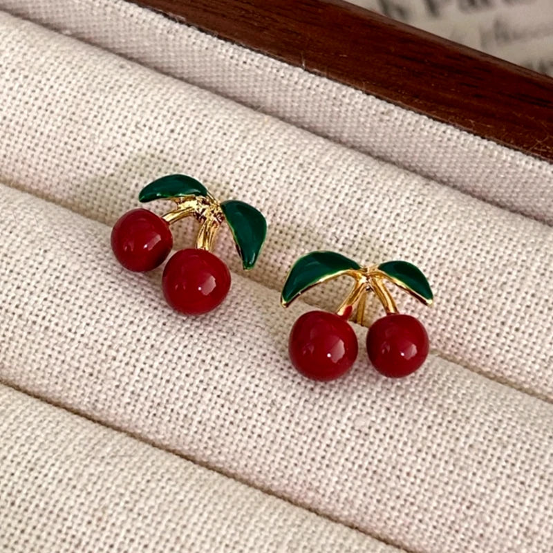 Model showcasing the dangle and style of the 14K Gold-Plated Cherry Earrings