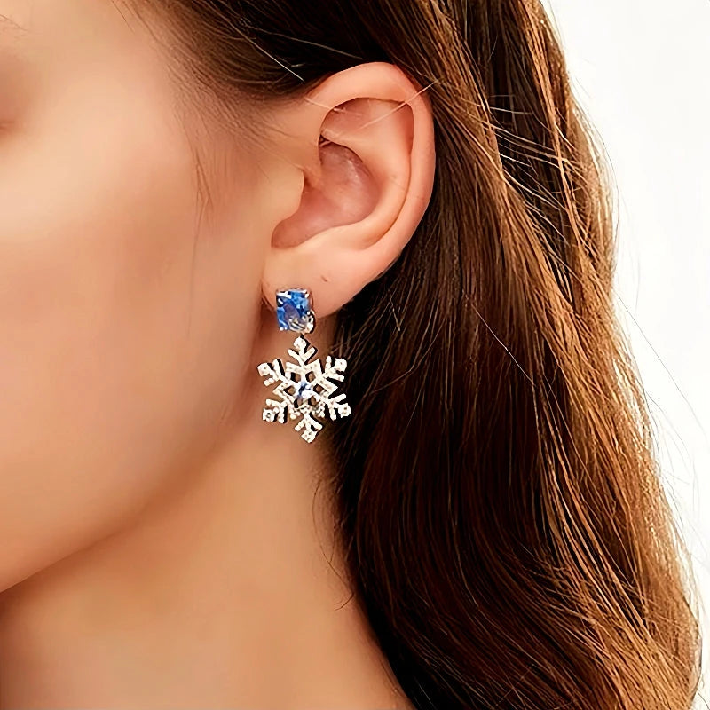 Model showcasing the dangle and style of the 14K Gold-Plated Christmas Diamond-Studded Ice And Snow Zircon Earrings