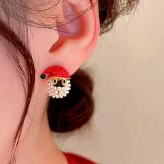 Model showcasing the dangle and style of the 14K Gold-Plated Christmas Diamond Santa Claus Hat Earrings
