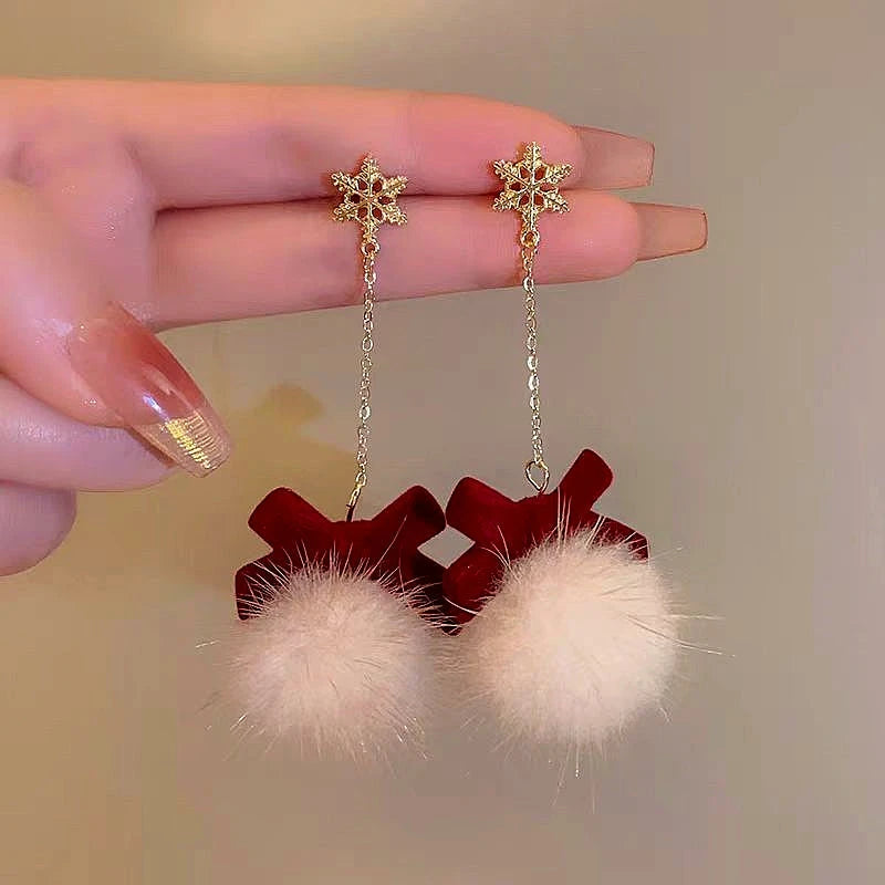 Angled view of the 14K Gold-Plated Christmas Fluffy Bow Earrings