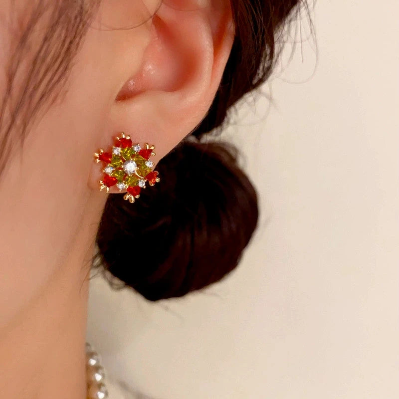 Model showcasing the dangle and style of the 14K Gold-Plated Christmas Full Diamond Snowflake Earrings