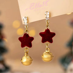 Model showcasing the dangle and style of the 14K Gold-Plated Christmas Red Star Bell Earrings