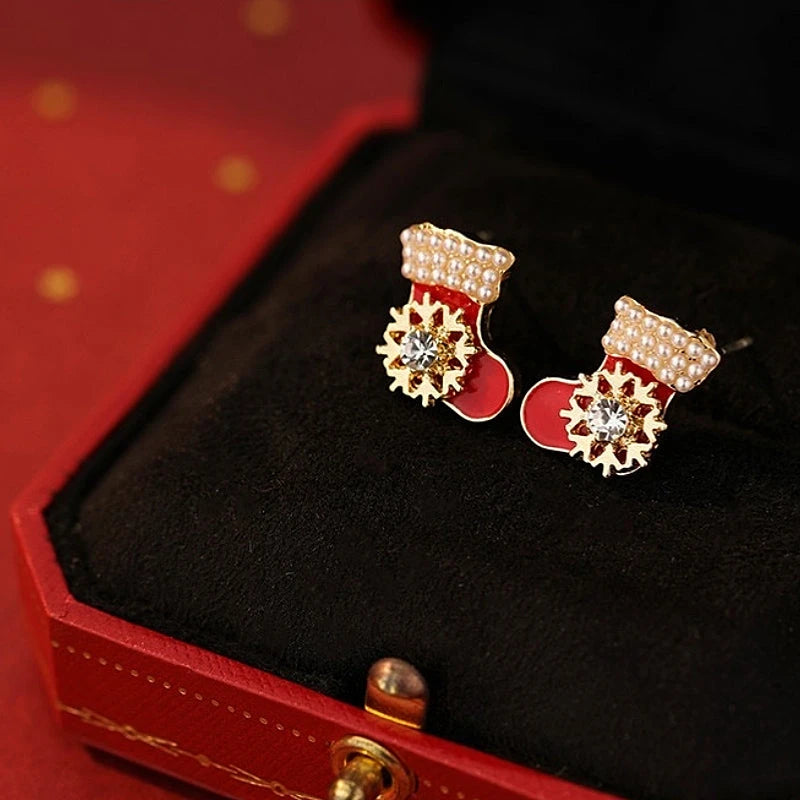 Model showcasing the dangle and style of the 14K Gold-Plated Christmas Rotatable Christmas Stock Stud Earrings