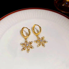 Angled view of the 14K Gold-Plated Christmas Snowflake Earrings