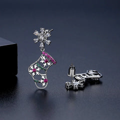 Model showcasing the dangle and style of the 14K Gold-Plated Christmas Stocking Zircon Snowflake Earrings