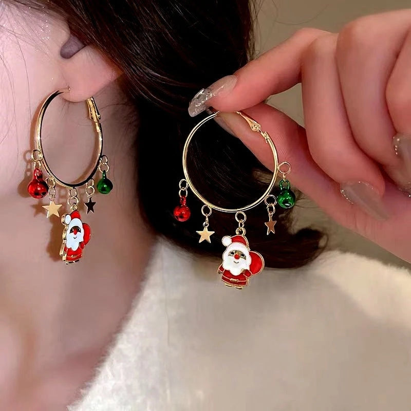 Model showcasing the dangle and style of the 14K Gold-Plated Christmas Tree And Santa Claus Hoop Tassel Earrings