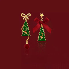 Model showcasing the dangle and style of the 14K Gold-Plated Christmas Tree Bow Earrings