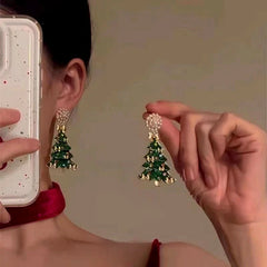 Model showcasing the dangle and style of the 14K Gold-Plated Christmas Tree Pearl Earrings