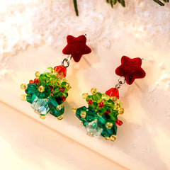Angled view of the 14K Gold-Plated Christmas Tree Star Earrings