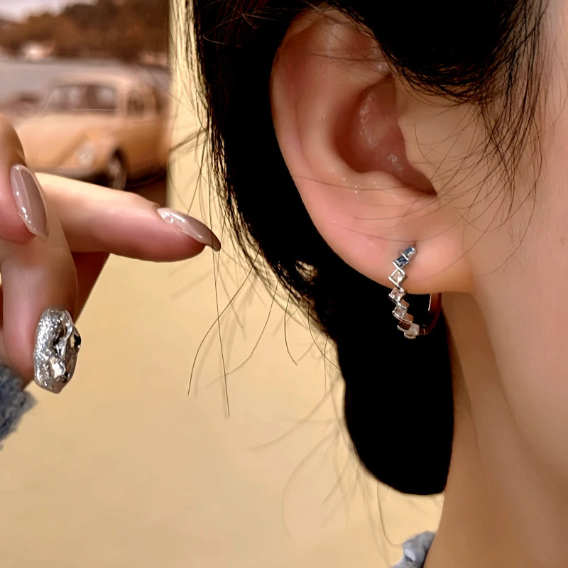 Model showcasing the dangle and style of the 14K Gold-Plated Colorful Diamond Hoop Earrings