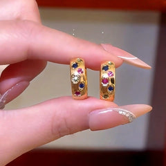 Model showcasing the dangle and style of the 14K Gold-Plated Colorful Zircon Diamond Hoop Earrings