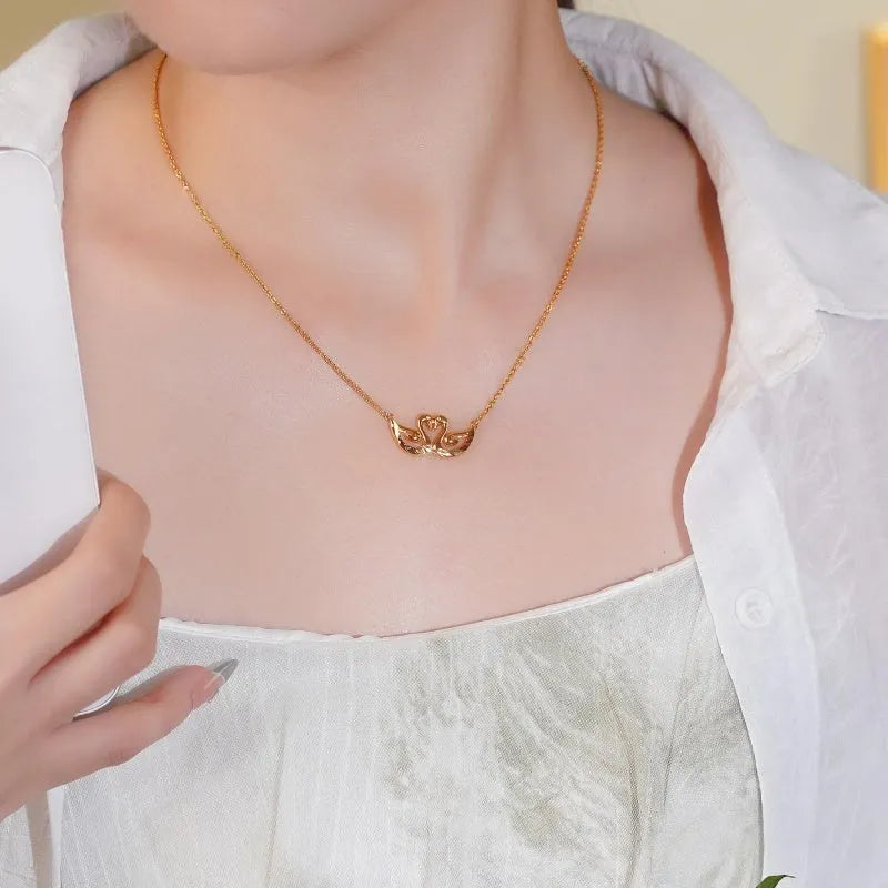 Close-up of the pendant and clasp on the Couple Swan Necklace