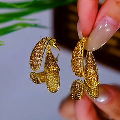 Close-up detail of the sparkling zircons and plating on the Golden Cross Earrings